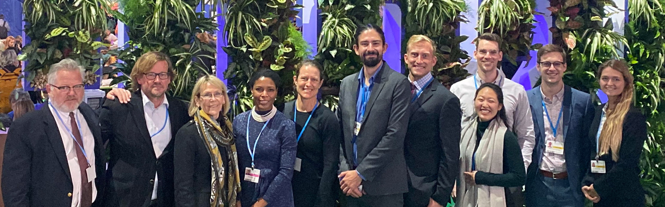 Professors and GPS students at COP26 posing together in a group.